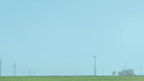 Wind turbines in green field with financial data processing animation overlay. Renewable, energy, sustainability, eco-friendly, innovation, technology - Powered by Shutterstock - Get 15% off with code: PIKWIZARD15
