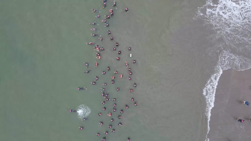 Drone overview of a swimmers, people racing in open water during daylight event in Regatas Cup