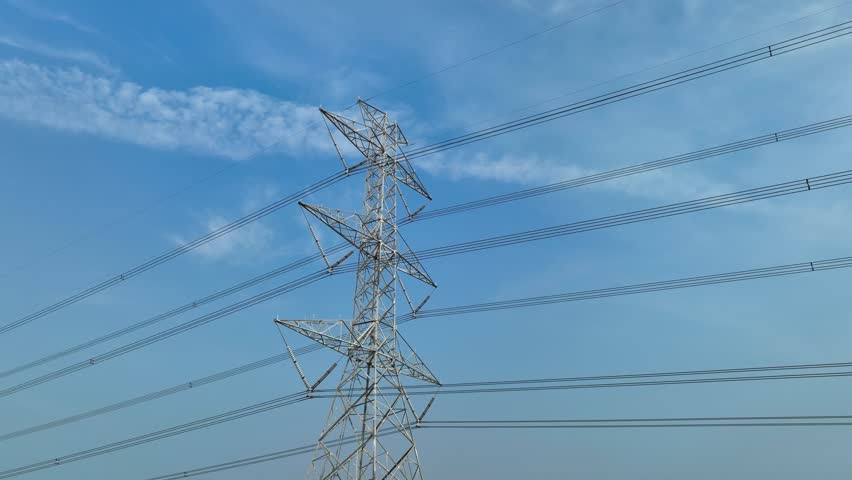 A high-angle view of a power tower that demonstrates both the complexity and efficiency of modern electrical distribution systems in keeping cities powered.
