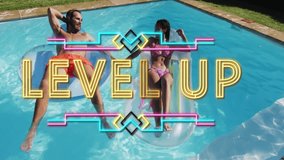 Couple relaxing on pool floats with Level Up text animation overlay. Vacation, leisure, relaxation, floating, swimming pool, summertime - Powered by Shutterstock - Get 15% off with code: PIKWIZARD15