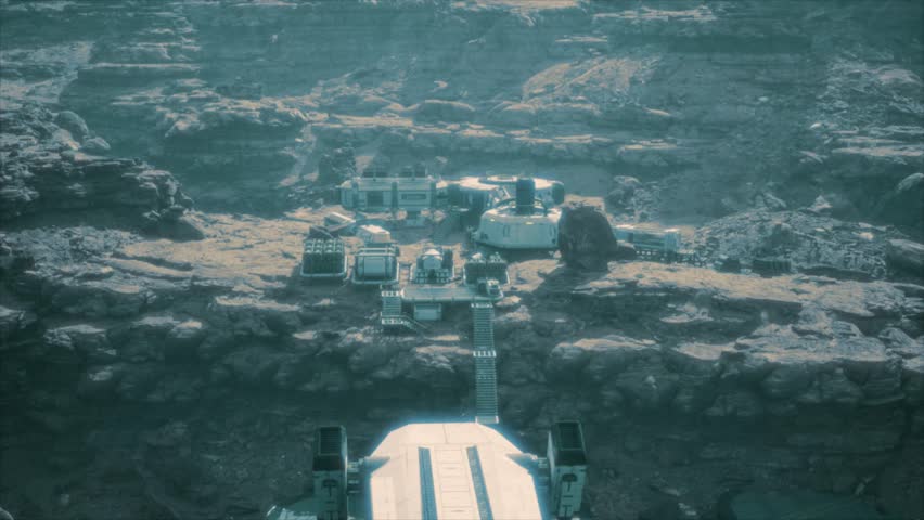 Aerial view over a human space settlement research base, on a cliff edge plateau on a barren rocky alien mars-like planet, surrounded by rugged mountains in a blue alien atmosphere