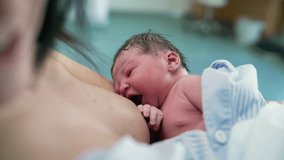 Close-up of a Newborn Infant Nursing Shortly After Birth Highlighting the Importance of Mother-Infant Connection and Postpartum Care - Powered by Shutterstock - Get 15% off with code: PIKWIZARD15