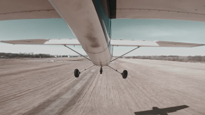 Cessna 150 performs precise centerline landing on a paved runway at a towered airport.