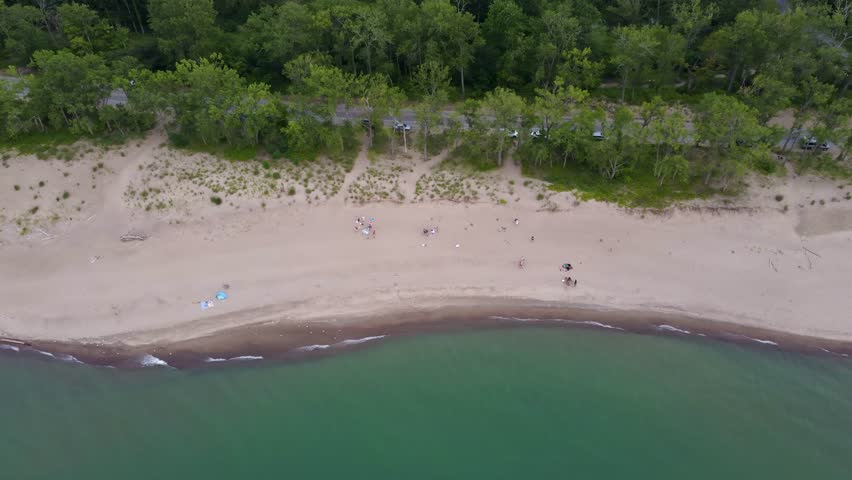 Presque Isle from above—golden beaches, lush green trees, and the vast blue of Lake Erie come together in this stunning aerial view of the state park.