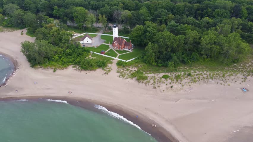 Fly over Presque Isle to witness its sun-kissed beaches, the deep blue of Lake Erie, and the dense green forests framing this scenic Pennsylvania gem.