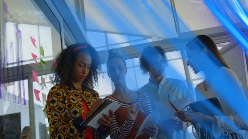 Collaborating on animation project, diverse group in school with blue light effects. Teamwork, creativity, students, diversity, collaboration, technology
