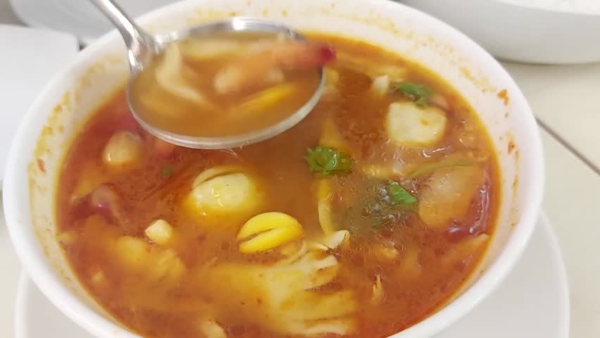 Tom Yum Seafood or Tom Yum Thai hot spicy soup served on a white bowl. Popular in Thailand. Thai food. Selective focus.