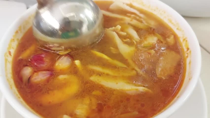 Tom Yum Seafood or Tom Yum Thai hot spicy soup served on a white bowl. Popular in Thailand. Thai food. Selective focus.