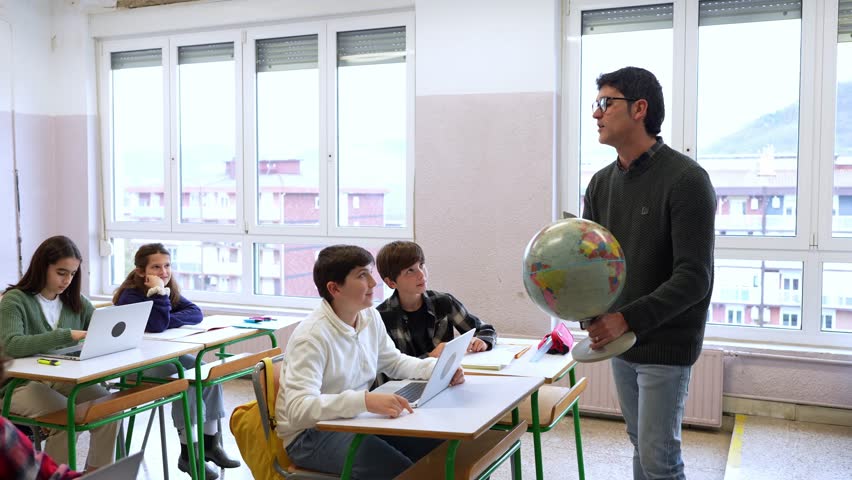 Geography instructor demonstrating world globe while engaging students in classroom learning environment, showcasing educational interaction and global knowledge exploration