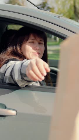Woman driving, food delivery to car in package. Food for driver, passenger to eat on road. Buying food in car. Delicious meal, for travelers by auto. Fast food concept, delivery through auto window