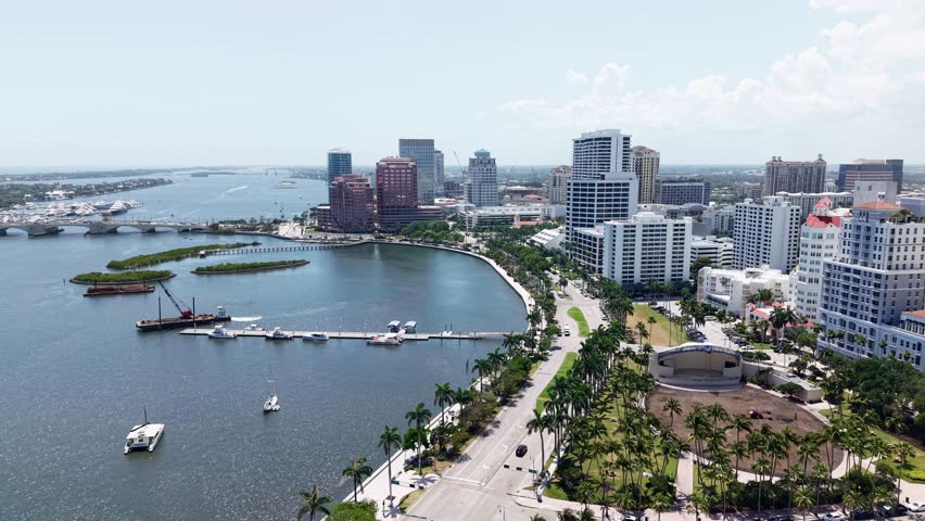 Drone flies over the calm bay near downtown West Palm Beach, Florida, on a bright clear day