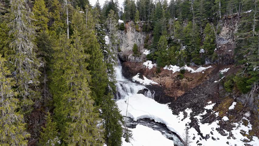 Reveal shot of Alexander Falls during early spring and melting snow in British Columbia, Canada