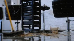 Broom Cleaning Hair Clippings from Floor in Contemporary Salon Setting - Powered by Shutterstock - Get 15% off with code: PIKWIZARD15