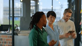 Diverse team collaborating on digital project with data processing animation overlay. Teamwork, collaboration, technology, innovation, diversity, brainstorming - Powered by Shutterstock - Get 15% off with code: PIKWIZARD15