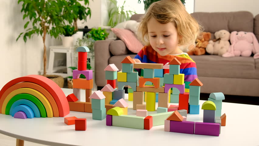 Children playing with blocks at home. Selective focus.
