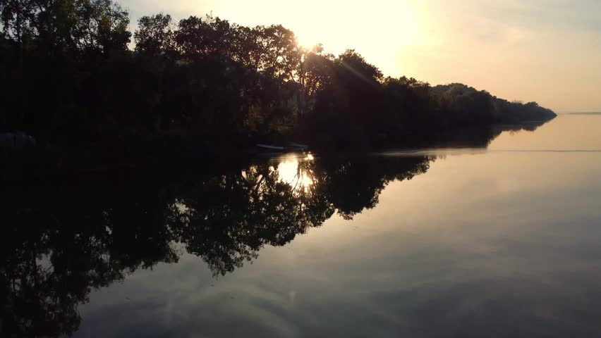 River landscape, Aerial View of reflection of forest trees and beautiful blue sky and clouds in the river, calm river lake, relaxation in nature in spring evening in jungles of Africa, Jijel Algeria.