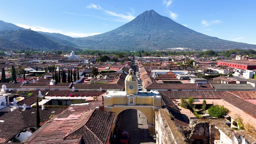 Beautiful aerial footage of the colonial town of Antigua Guatemala. The Yellow arch clock of Santa Catalina Convent, Cathedral Antigua and the Royal Palace of the Captains General