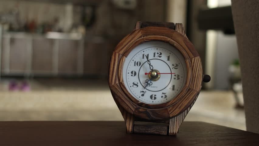 Amsterdam, Netherlands – 10april , 2025. quartz, Wooden analog clock sitting on a table in soft lighting with visible time progression captured as a timelapse. Ideal for symbolic visuals of time pass