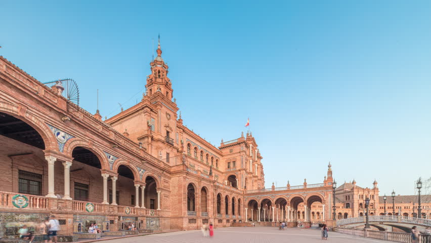 Plaza de Espana in Seville timelapse hyperlapse, a grand architectural complex in Maria Luisa Park built for the Ibero-American Exposition. Bridges and vintage streetlights during sunset