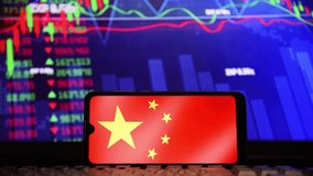 Chinese flag on a cell phone screen, and random stock market charts are shown in the background. Concept of economy, crisis, stock market and financial market. - Powered by Shutterstock - Get 15% off with code: PIKWIZARD15