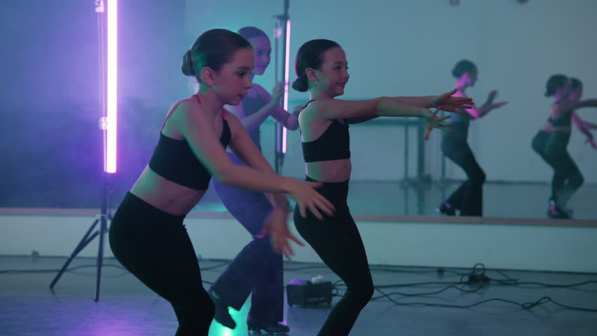Young girls in a modern tap dance class practicing their routine