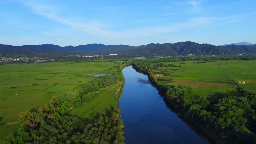 River landscape, Aerial View of reflection of forest trees and beautiful blue sky and clouds in the river, calm river lake, relaxation in nature in spring evening in jungles of Africa, Jijel Algeria.