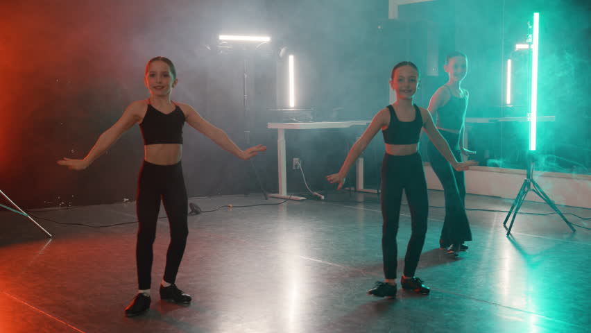 Young girls in a modern tap dance class practicing their routine