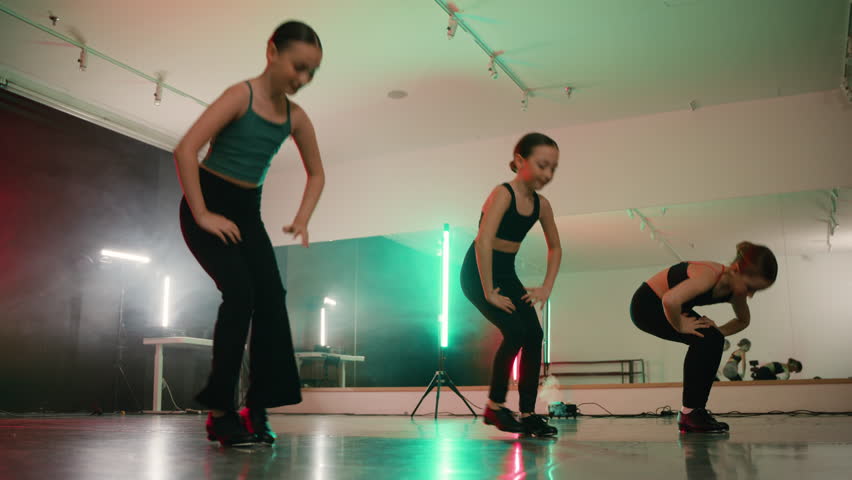 Young girls in a modern tap dance class practicing their routine
