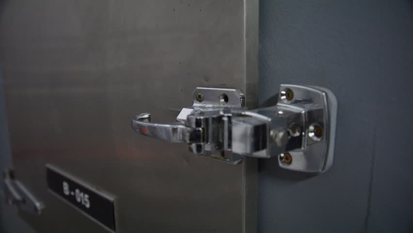 Morgue worker revealing body in a fridge