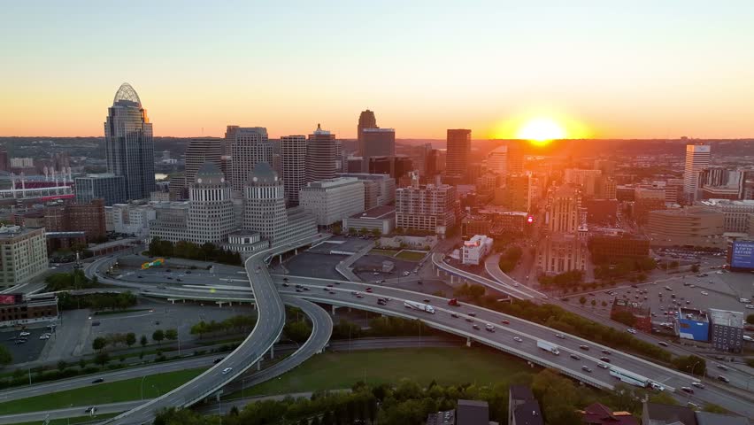Aerial Sunrise Over Cincinnati Skyline and Ohio River Tracking Shot