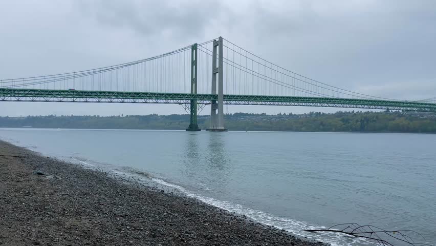 Cars passing over Tacoma Narrows Bridge as viewed from the water in Tacoma, Washington