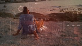 Man sitting on rocky shore with digital interface animation overlay. Technology, innovation, virtual, futuristic, augmented, environment - Powered by Shutterstock - Get 15% off with code: PIKWIZARD15