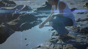 Sitting on rocks by ocean, elderly person viewing animation of digital network. Technology, nature, connectivity, senior, virtual reality, outdoors - Powered by Shutterstock - Get 15% off with code: PIKWIZARD15