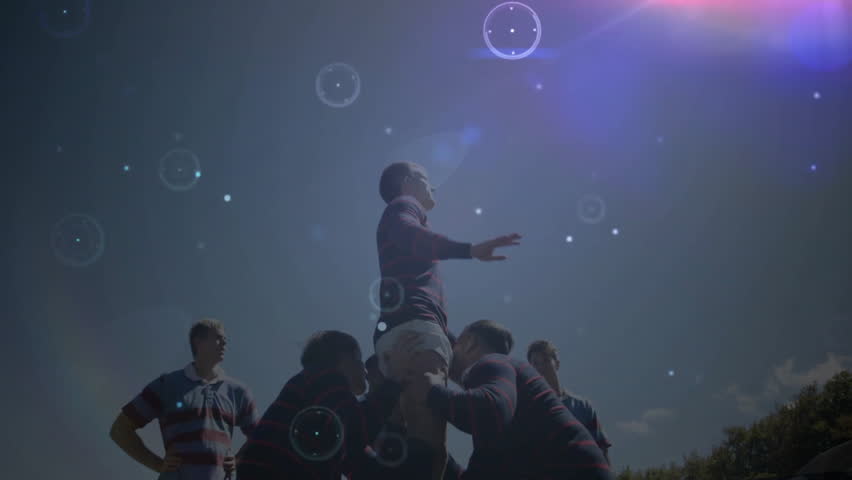 Rugby players lifting teammate with digital data processing animation overlay. teamwork, sports, dynamic, digital overlay, motion, athletic - Powered by Shutterstock - Get 15% off with code: PIKWIZARD15