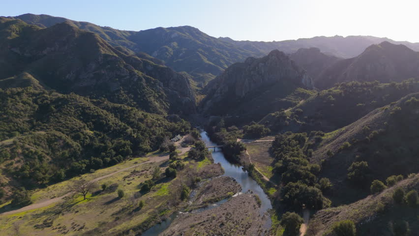 Discover stunning aerial views of Malibu Hills, where lush greenery meets a winding river, showcasing natures breathtaking beauty that enchants every visitor to this incredible destination