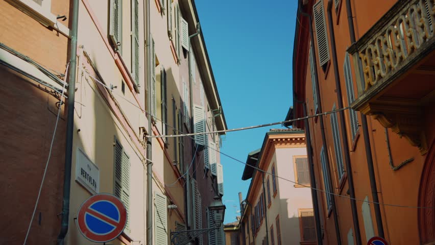 A Charming Street View Showcasing Colorful Italian Architecture Beneath a Clear Blue Sky