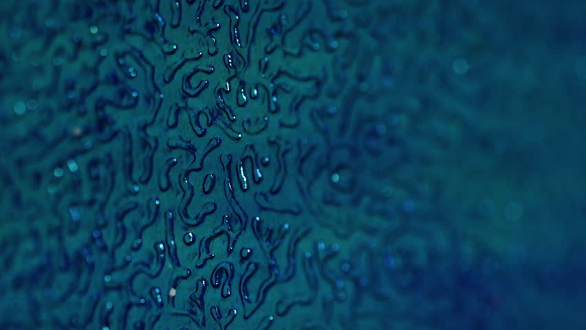 Bokeh material. Embossed plastic surface. Blue grainy artificial leather glisten wavy sheet with changing lighting. Decorative defocused flare background.