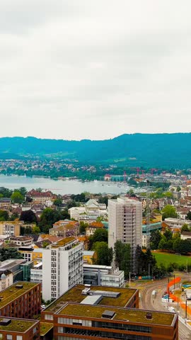 Vertical video. Zurich, Switzerland. Panorama of the city overlooking Lake Zurich. Summer day, Aerial View. Rich colors
