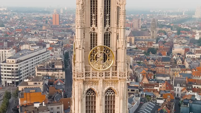 Dolly zoom. Antwerp, Belgium. Spire with the clock of the Cathedral of Our Lady (Antwerp). Historical center of Antwerp. City is located on river Scheldt (Escaut). Summer morning, Aerial View