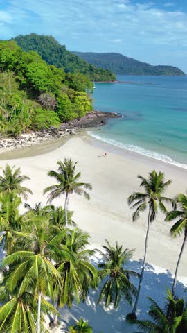 Discover the serene beauty of Koh Kood Island in Thailand, where turquoise waters meet soft sandy beaches framed by swaying palm trees. A perfect escape for relaxation and adventure.