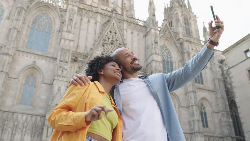 Tourists taking selfies in front of barcelona cathedral