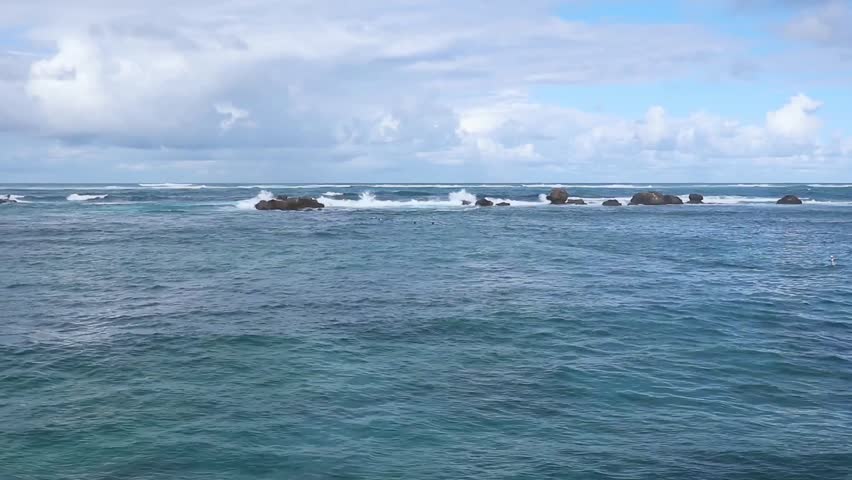 waves on the beach in front of luxury hotel in the condado neighborhood of old san juan puerto rico (famous tourism travel destination caribbean sea) ocean waves water sport paddle boarding surf water