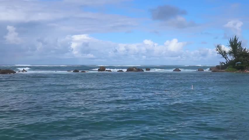 waves on the beach in front of luxury hotel in the condado neighborhood of old san juan puerto rico (famous tourism travel destination caribbean sea) ocean waves water sport paddle boarding surf water