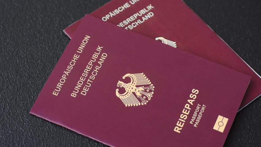 German citizen passport against the background of the German national flag as a background for your design