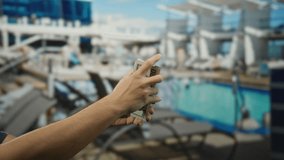 Man holding american dollars on a cruise ship by the pool, showcasing travel and lifestyle with leisure in a financial context outdoors. - Powered by Shutterstock - Get 15% off with code: PIKWIZARD15