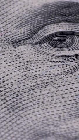 100 US dollar banknote Extreme macro. Fragment of one hundred dollar bill close-up. Detail view of USD currency cash. Vertical footage