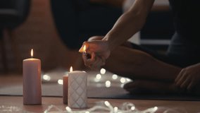 Calm African American female lighting candles and meditating at home, doing yoga - Powered by Shutterstock - Get 15% off with code: PIKWIZARD15