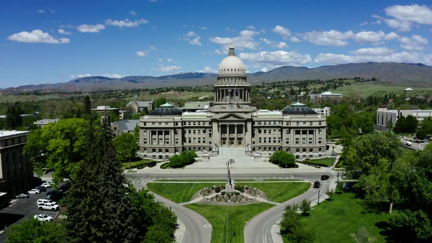 Aerial shot slowly pushing towards the Boise state capital building at midday.