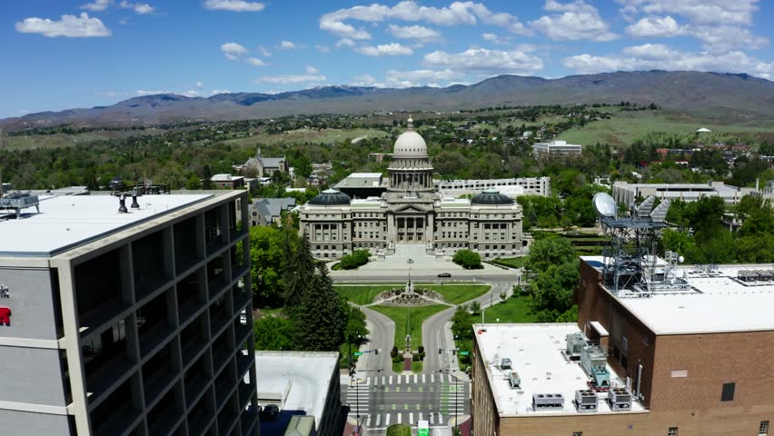 Wide drone shot approaching the Idaho capital building on a summer day.