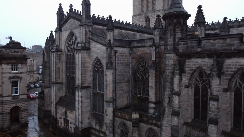 Drone rising around the St Giles cathedral, gloomy day in Edinburgh, Scotland